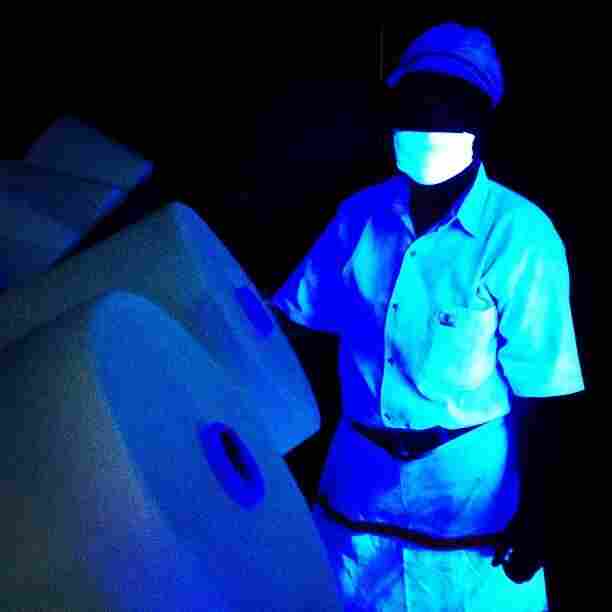 Yarn is checked for contamination in the UV light room. Even a single strand of hair will show up.