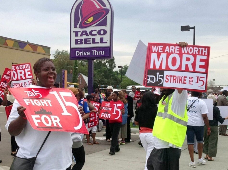 Outside a Taco Bell restaurant in Warren, Mich., early Thursday, supporters of the push by fast-food workers to raise the minimum wage were marching. (Jessica J. Trevino /MCT/Landov)