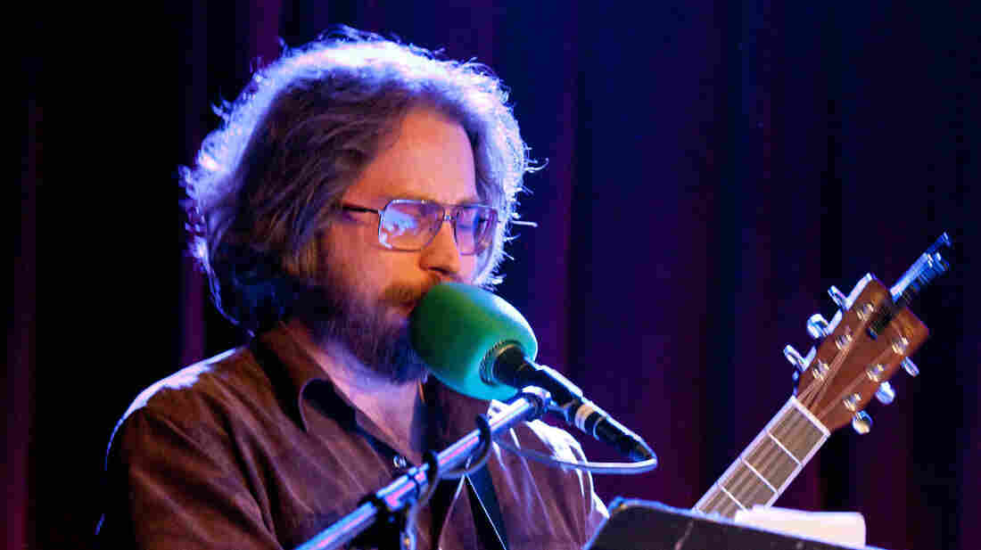 House musician Jonathan Coulton works his way through a rendition of the Twisted Sister anthem "We're Not Gonna Take It"...although its lyrics have been reworked as clues to baked goods.
