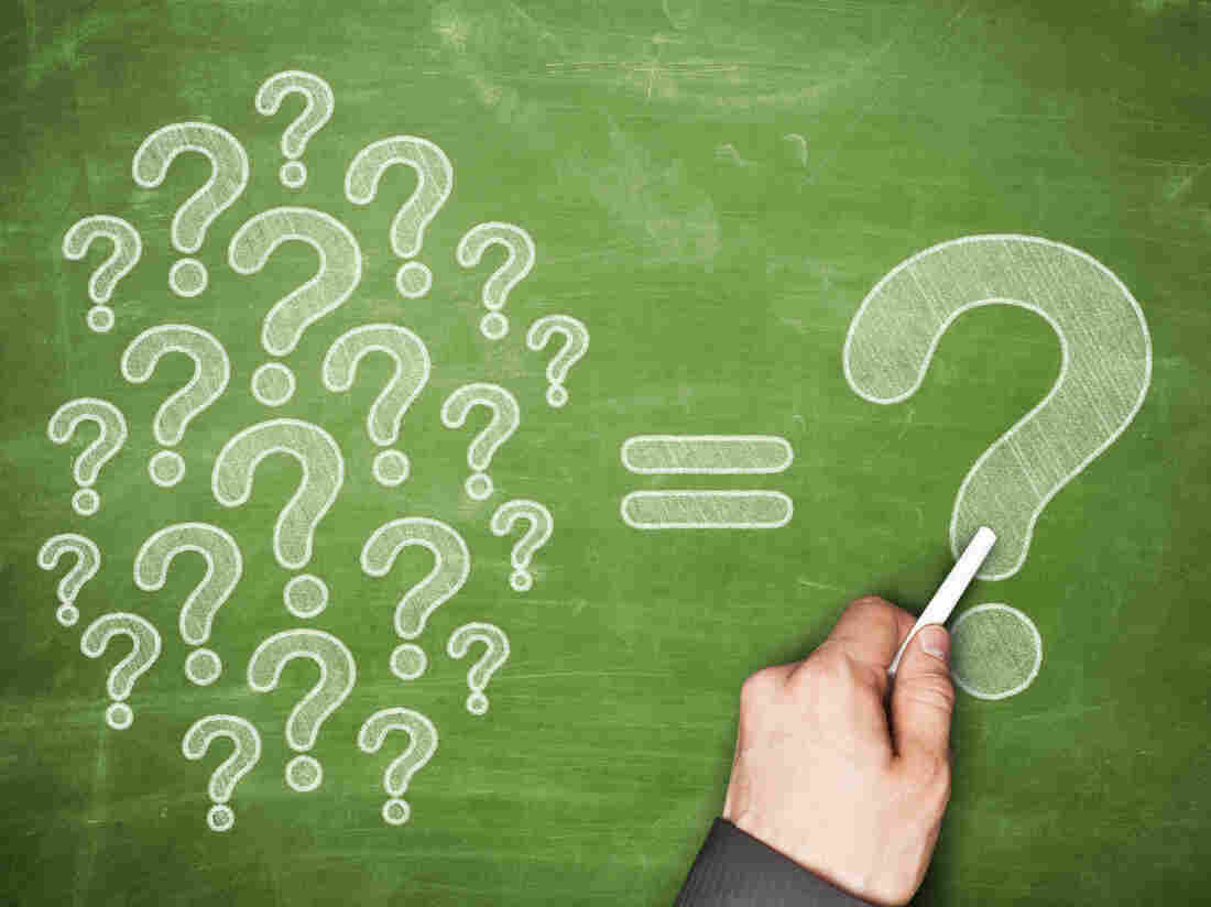 A bunch of question marks on a chalk board.