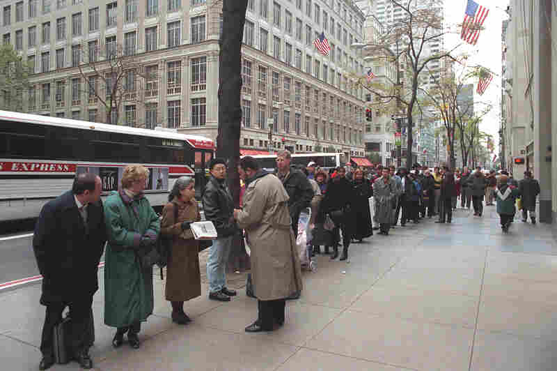 People form a line on 5th Avenue extending around the corner as they wait for the U.S. Passport Office to open in New York's Rockefeller Center, Nov. 13. With the clock ticking toward a midnight shutdown, President Clinton vetoed a temporary borrowing bill and prepared to close most government operations.