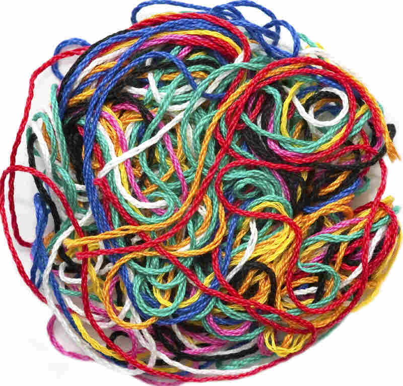 A colorful, tangled ball of yarn or thread.