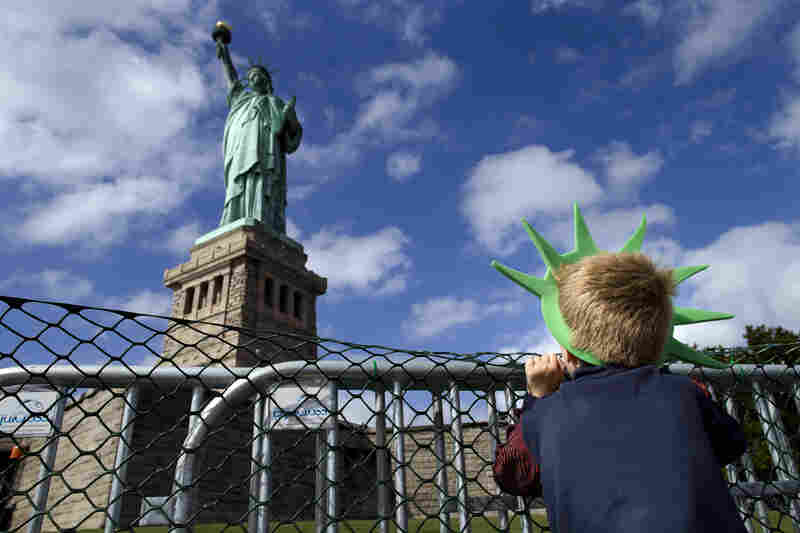Jackson Blendowski, 6, peers up at the Statue of Liberty in New York Harbor on Oct. 13. The Statue of Liberty reopened to the public after the state of New York agreed to shoulder the costs of running the site during the shutdown.