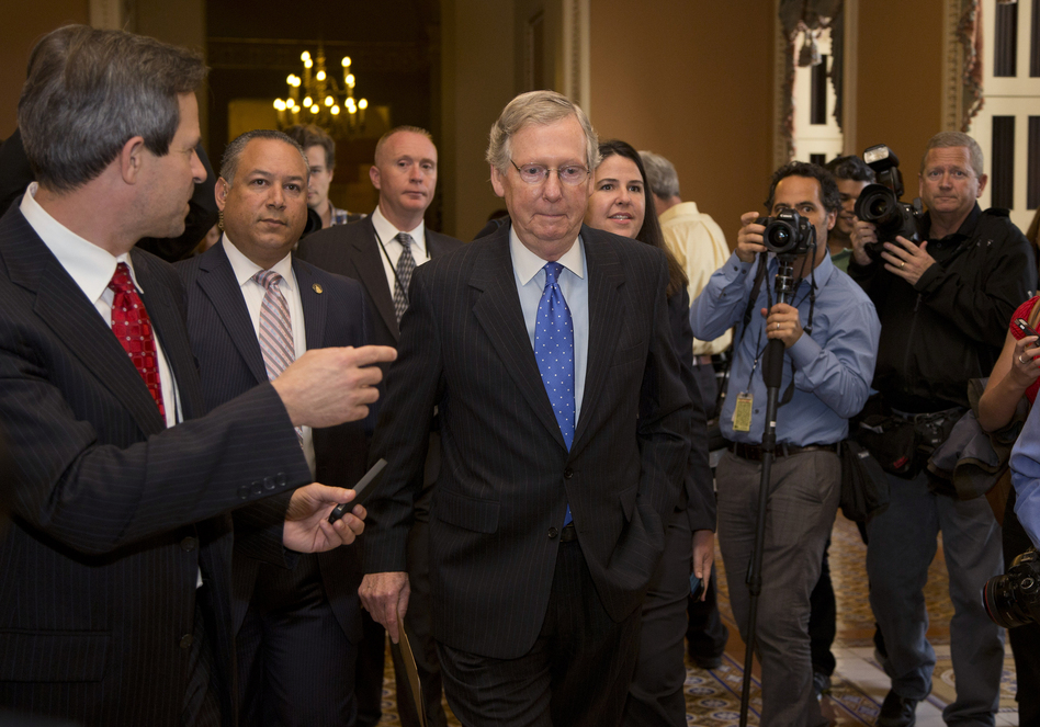 Senate Minority Leader Sen. Mitch McConnell, R-Ky., walks to the Senate floor after agreeing to the framework of a deal to avoid default and reopen the government, on Capitol Hill on Wednesday. (Carolyn Kaster/AP)