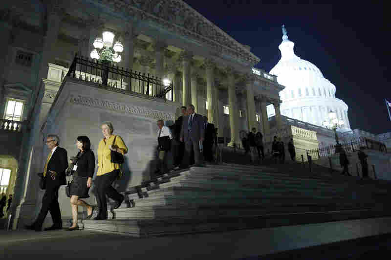 Members of the House of Representatives depart after a late-night vote Wednesday on legislation to raise the debt ceiling and end the government shutdown. President Obama signed the bill just after midnight.