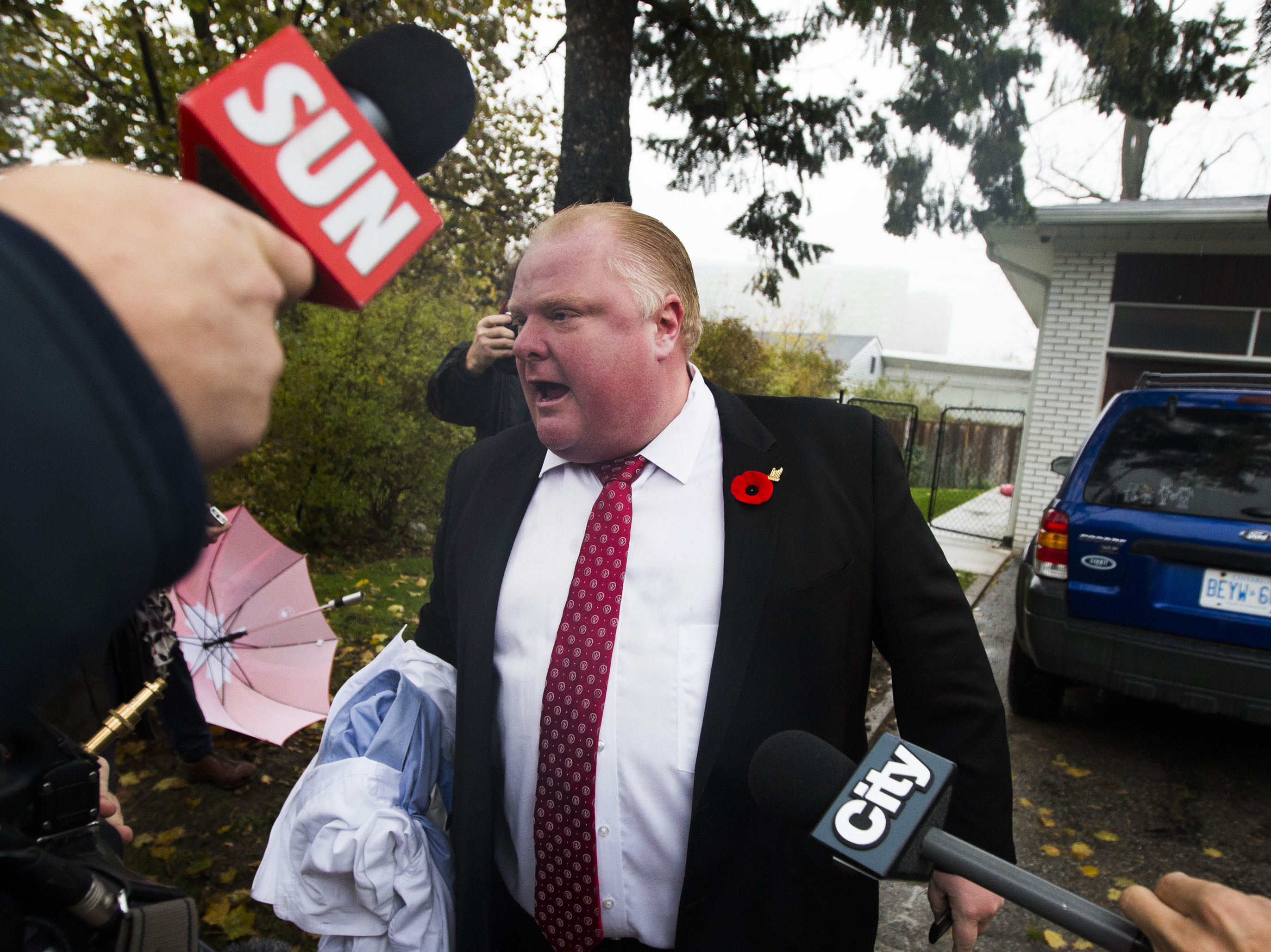 When he emerged from his home Thursday morning, Toronto Mayor Rob Ford found reporters in his driveway. As they peppered him with questions, he shouted that they had to get out of his way. He didn't respond to questions about a video that allegedly shows him smoking crack. (Reuters /Landov)