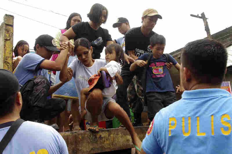 Those living near the slopes of Mayon volcano were evacuated to public schools by police in anticipation of the typhoon. 