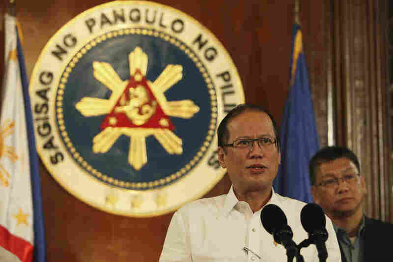Philippine President Benigno Aquino III, with Executive Secretary Paquito Ochoa Jr., speaks about the storm during a nationally televised address at the Malacanang Palace in Manila.