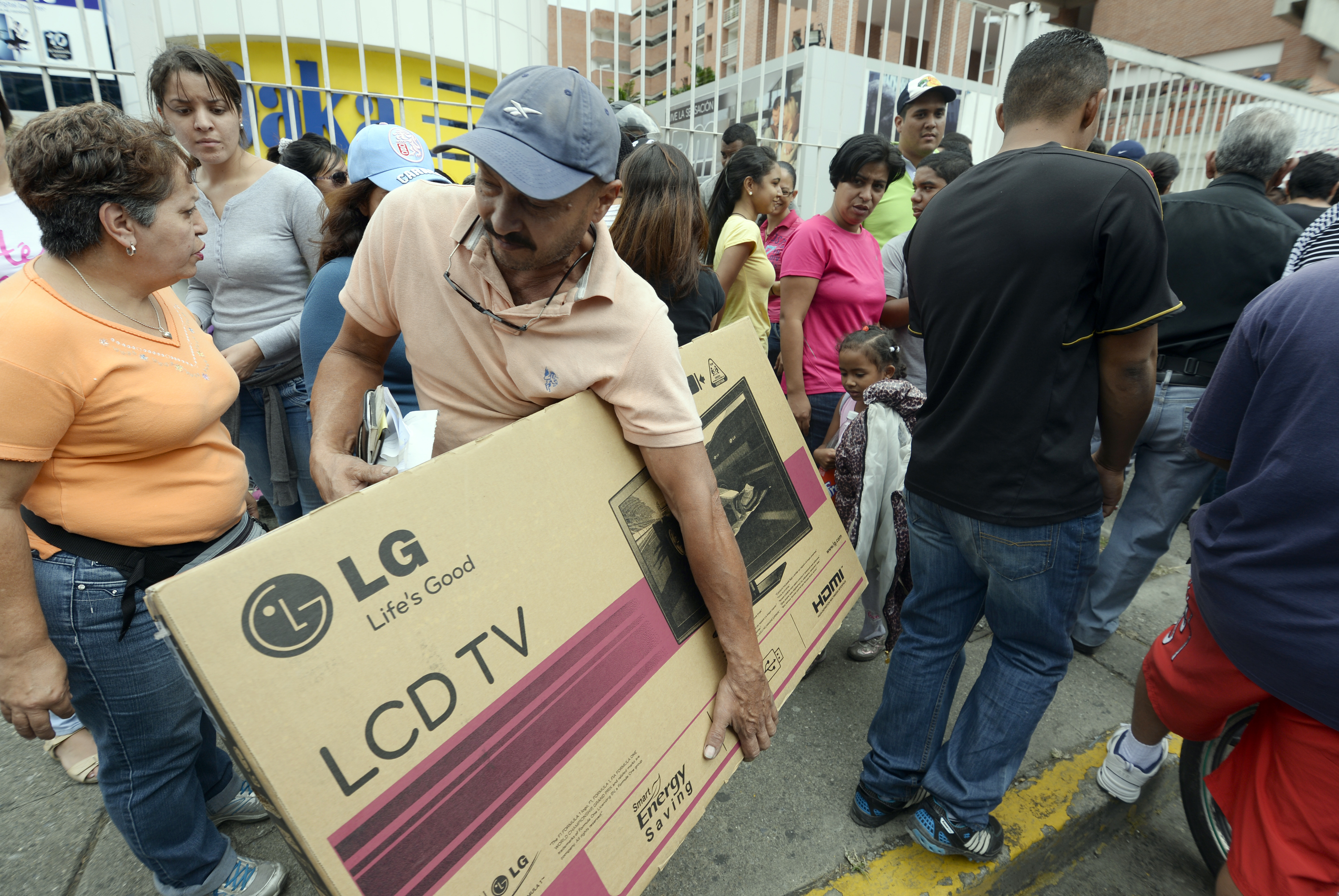 Shoppers loaded with purchases leave a Daka store in Caracas on Saturday. (AFP/Getty Images)