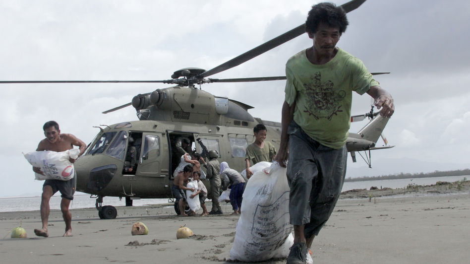 Survivors of Typhoon Haiyan in the central Philippines coastal village of Capiz got some help Monday when a Filipino military helicopter brought some much-needed food. (Tara Yap/AFP/Getty Images)