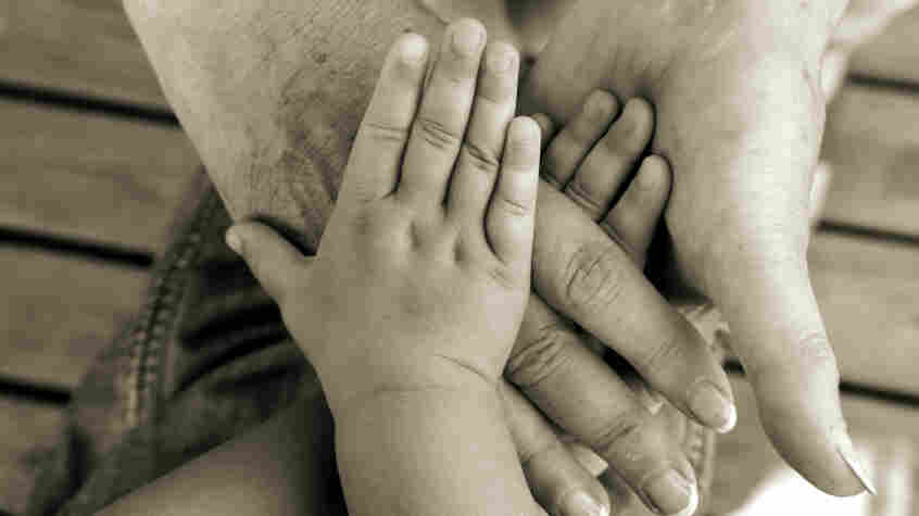 Hands of different ages in a circle.