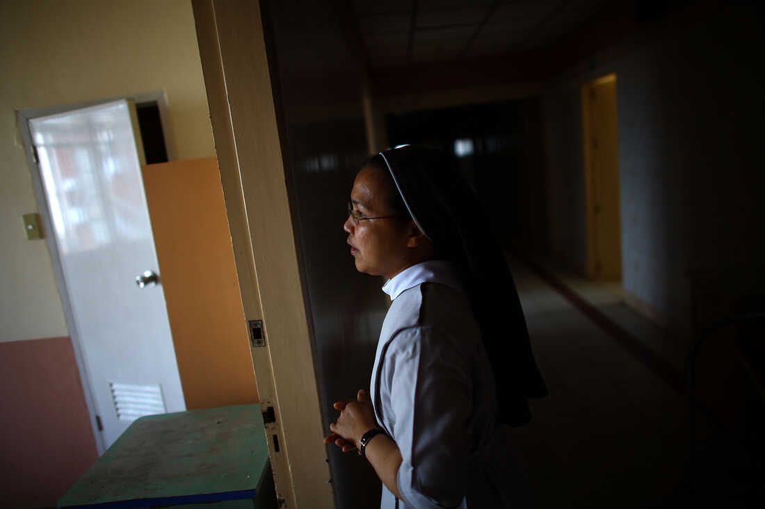 Sister Eliza Arpon checks on the condition of the damaged ward rooms and ER facilities at Divine Word Hospital in Tacloban, Philippines, on Saturday.