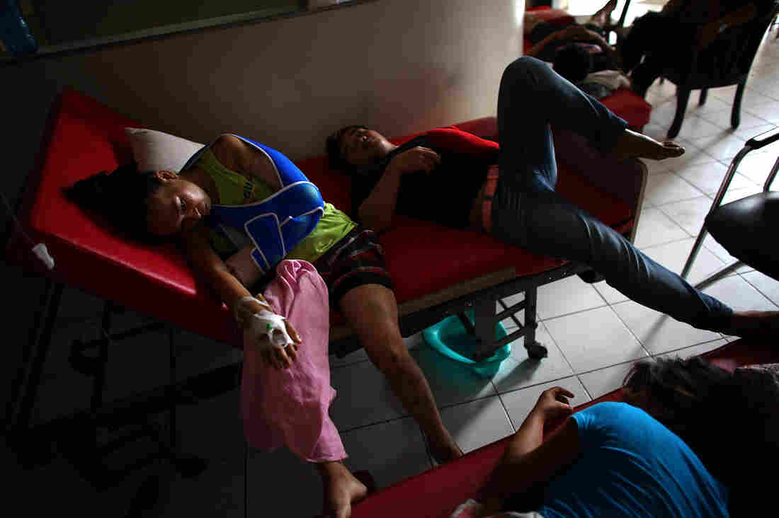 Patients lay in a makeshift waiting area in the halls of the Divine Word Hospital in Tacloban, Philippines, on Saturday.