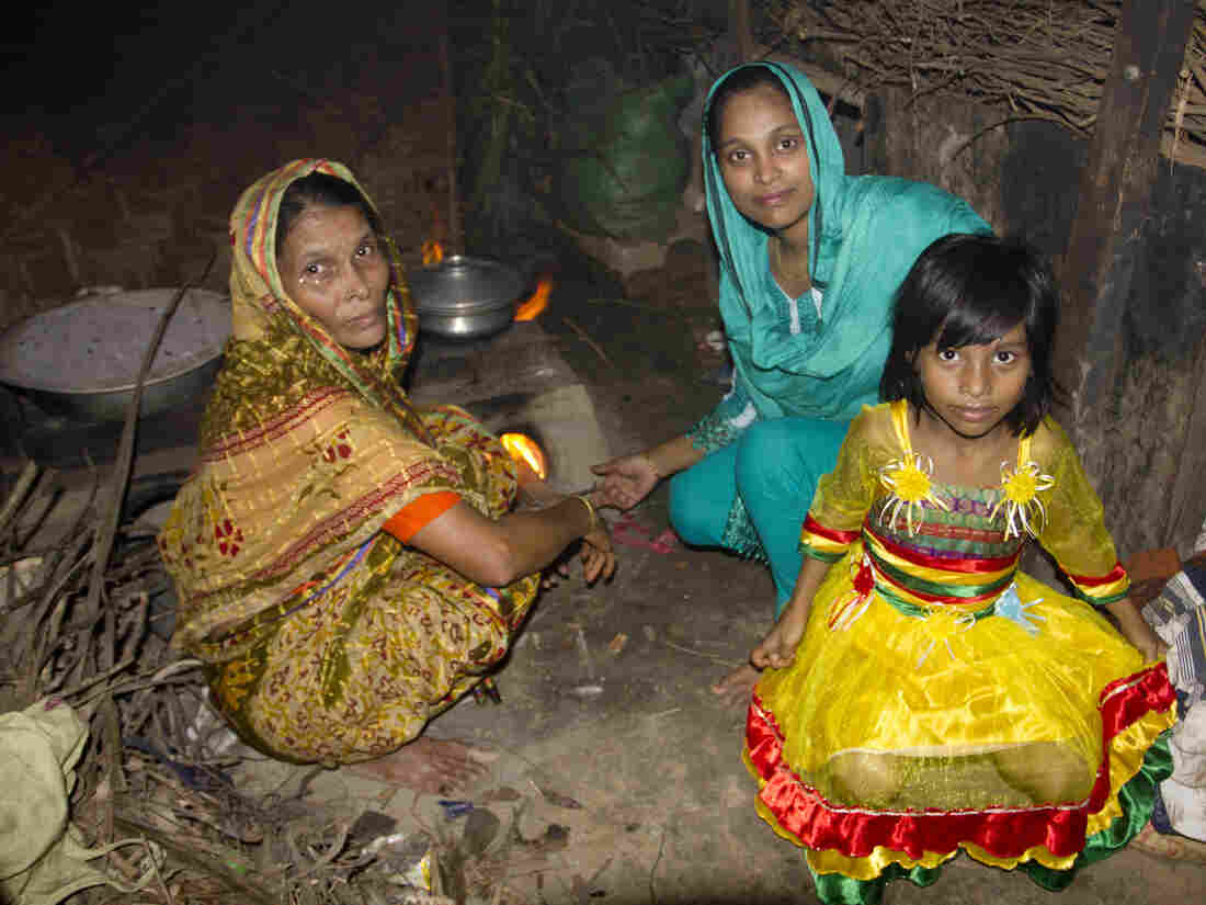 Minu's mother, Noor Jahan Begum, Minu, and Minu's daughter, Sumaiya, in the kitchen of Minu's parent's home.