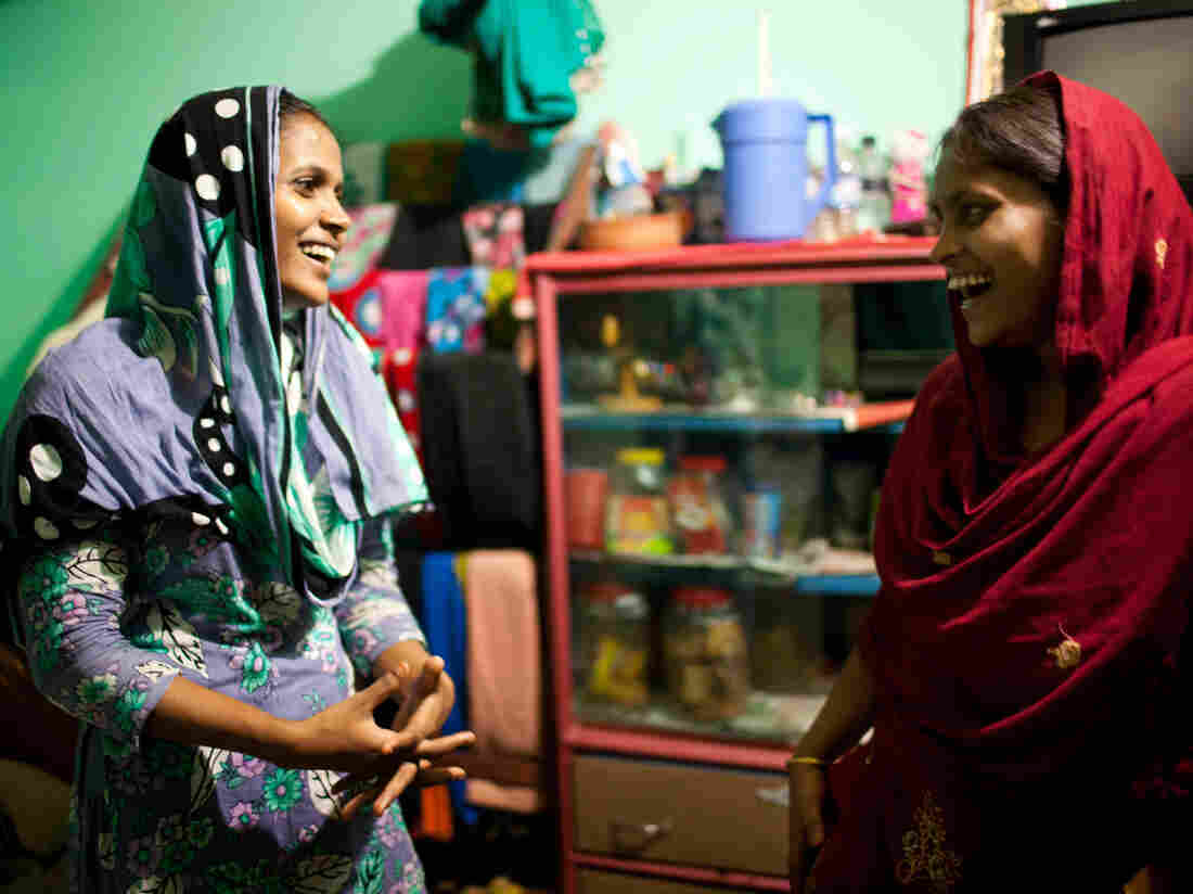 Shumi, left, and Minu, right, inside the small room they share with Minu's husband.