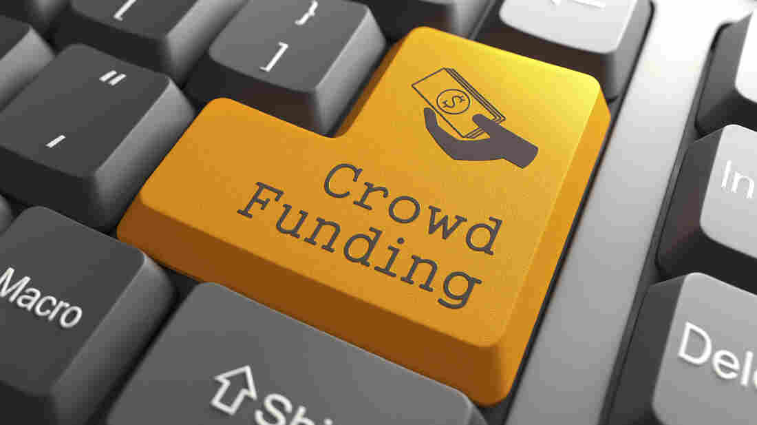 A "Crowd Funding" button on a computer keyboard