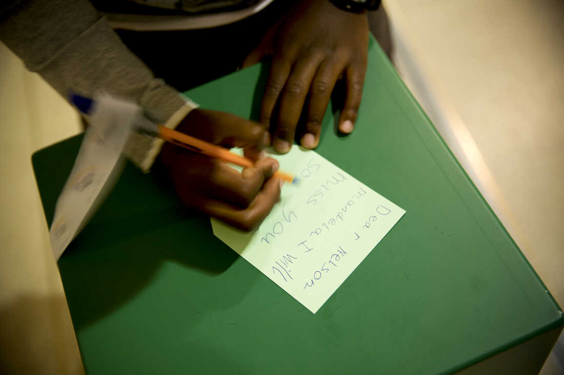 A young boy writes a goodbye message to Mandela at Cape Town's Civic Center Nelson Mandela exhibition. The exhibition opened earlier this year in celebration of Mandela's 95th birthday.