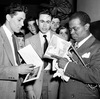 Jazz trumpeter Louis Armstrong signs autographs in the Blue Note nightclub in Chicago in 1948.