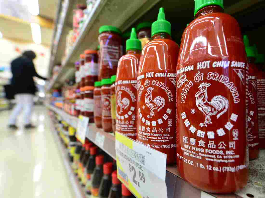 Bottles of Sriracha chili sauce on the shelves of a supermarket in Rosemead, Calif.