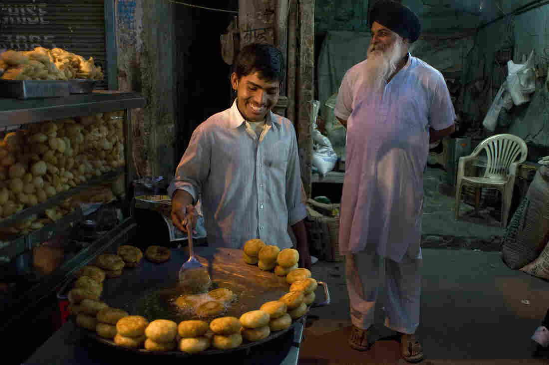 An Indian chaat, or savory snack, vendor fries potato patties on a stall at a market in New Delhi on April 4.