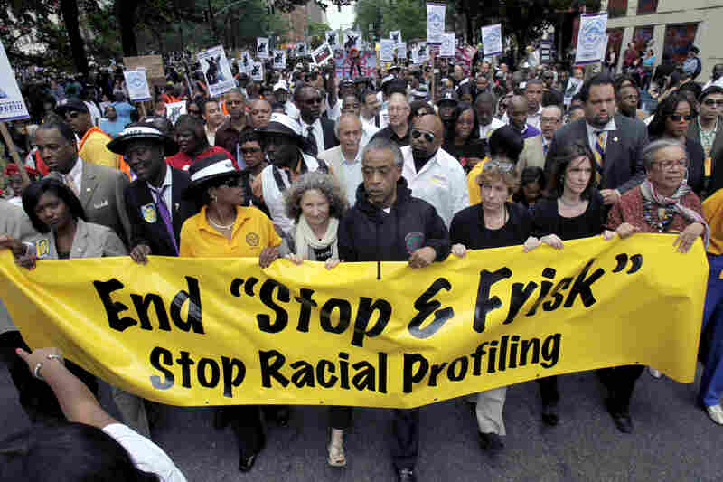 The Rev. Al Sharpton (center) walks with demonstrators during a silent march to end the "stop and frisk" program in New York on June 17, 2012. Thousands of protesters from civil rights groups marched in defiance of the tactics employed by city police.