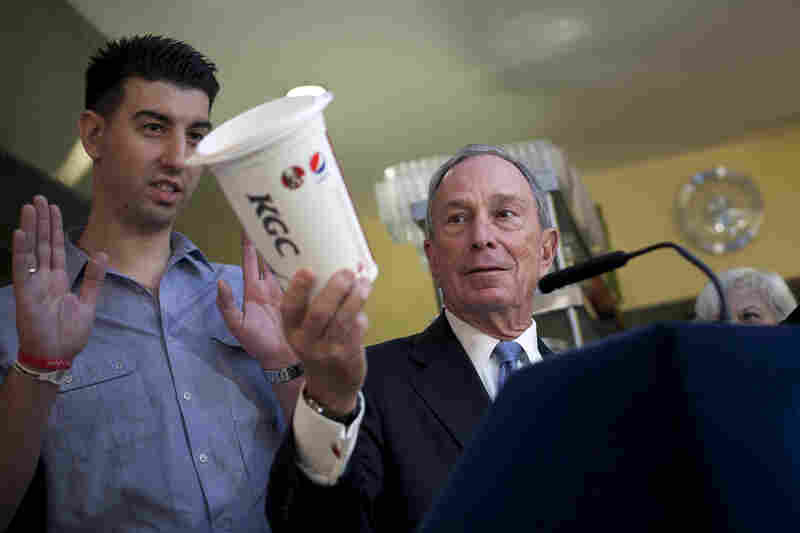 Bloomberg holds a large cup as he speaks to the media about the effects of sugar on health at Lucky's restaurant, which voluntarily adopted a ban on large sugary drinks, March 12 in New York City. A state judge blocked Bloomberg's ban.