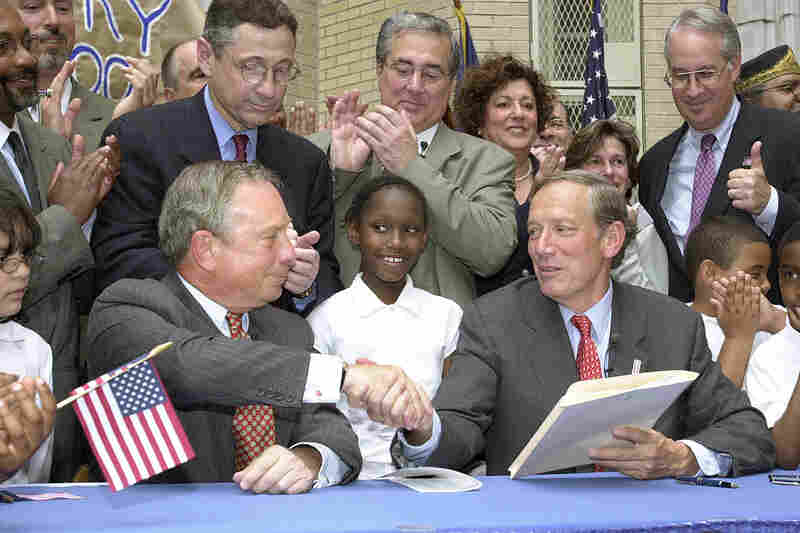 Bloomberg shakes hands with Gov. George Pataki after Pataki signed city school governance legislation June 12, 2002. The legislation gave Bloomberg control of the city's school system. 