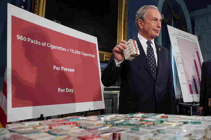 Bloomberg stands near a display of cigarettes during a news conference at City Hall, where he announced that New York City had filed a lawsuit against eight smoke shops on an Indian reservation on Long Island, on Sept. 29, 2008.