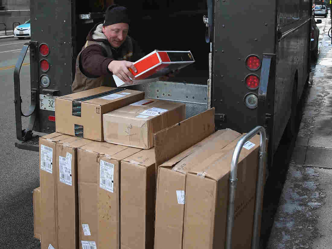 A UPS worker delivers packages Thursday in Chicago. Bad weather and a higher than expected demand from online sales caused FedEx and UPS to miss some Christmas delivery deadlines.