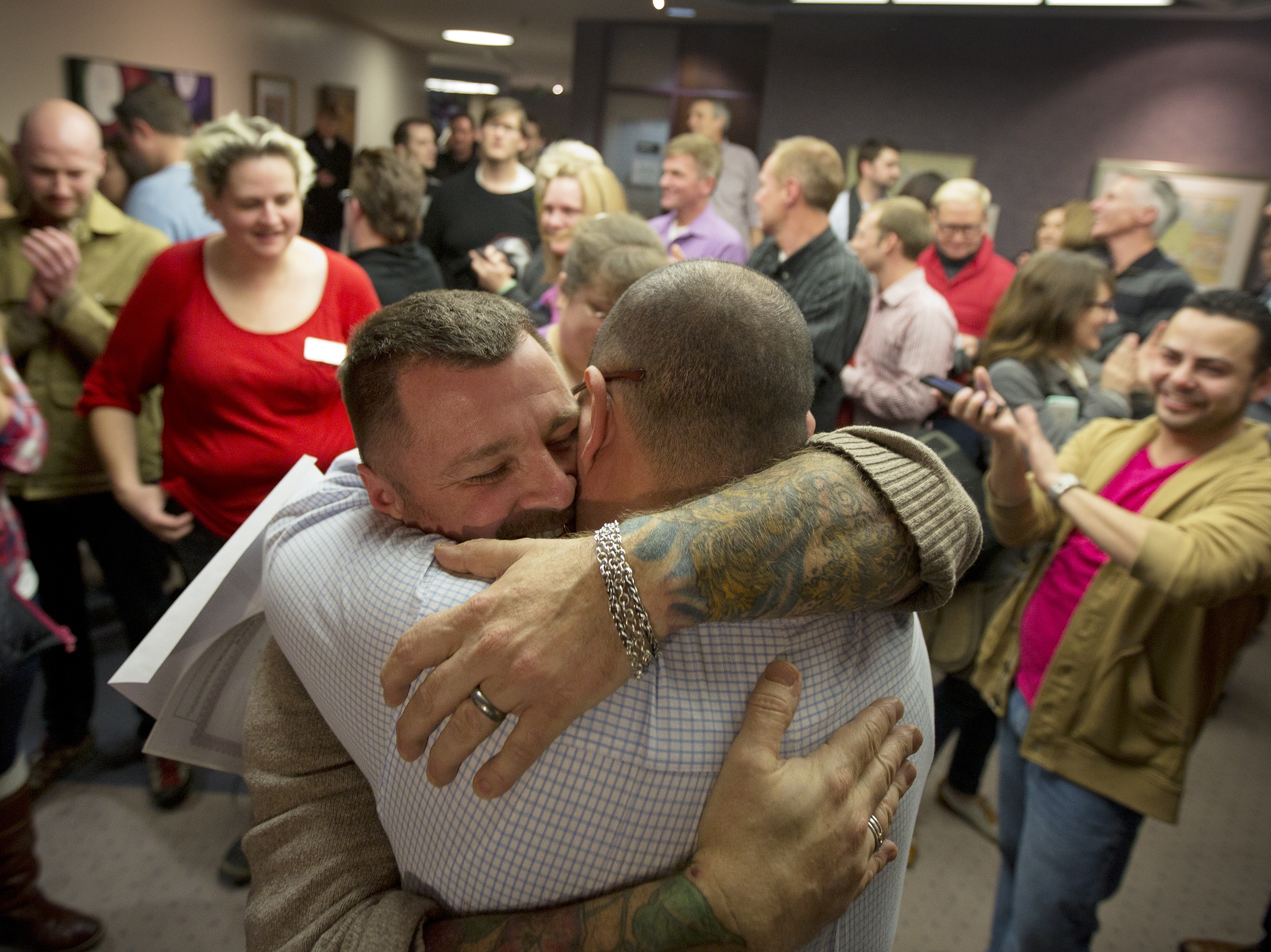 Chris Serrano, left, and Clifton Webb embrace after being married on Dec. 20 in the Salt Lake County Clerk's Office in Salt Lake City.