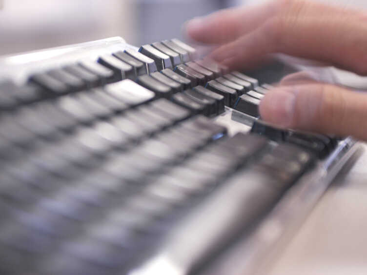 Hands typing on a keyboard
