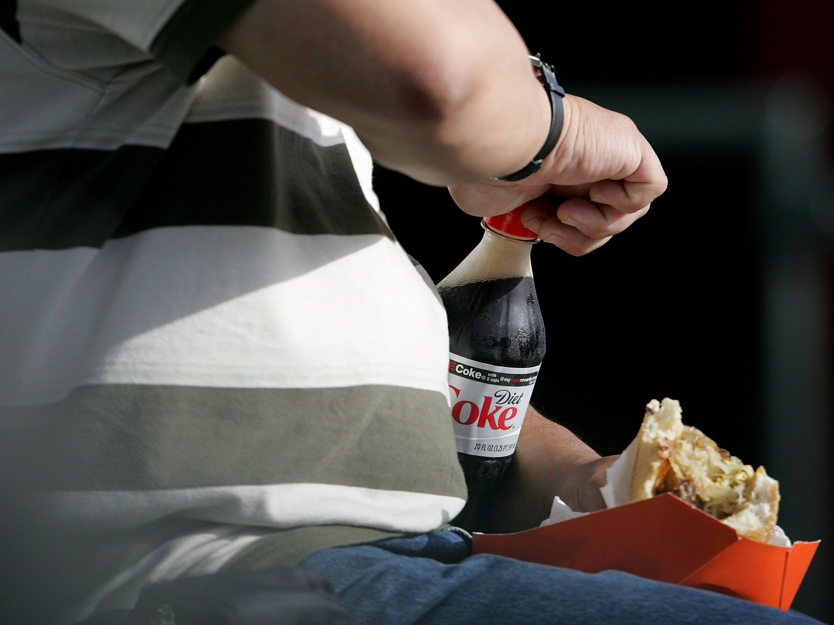 Ditching sugar-sweetened drinks in favor of diet ones shaves the empty calories. But it doesn't help if you make up for those calories on your plate. (Getty Images)