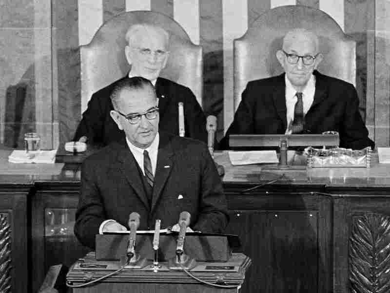President Lyndon B. Johnson delivers his State of the Union address to a joint session of Congress on Jan. 8, 1964. In the background are Speaker John McCormack and Sen. Carl Hayden, right, Senate president pro tem.