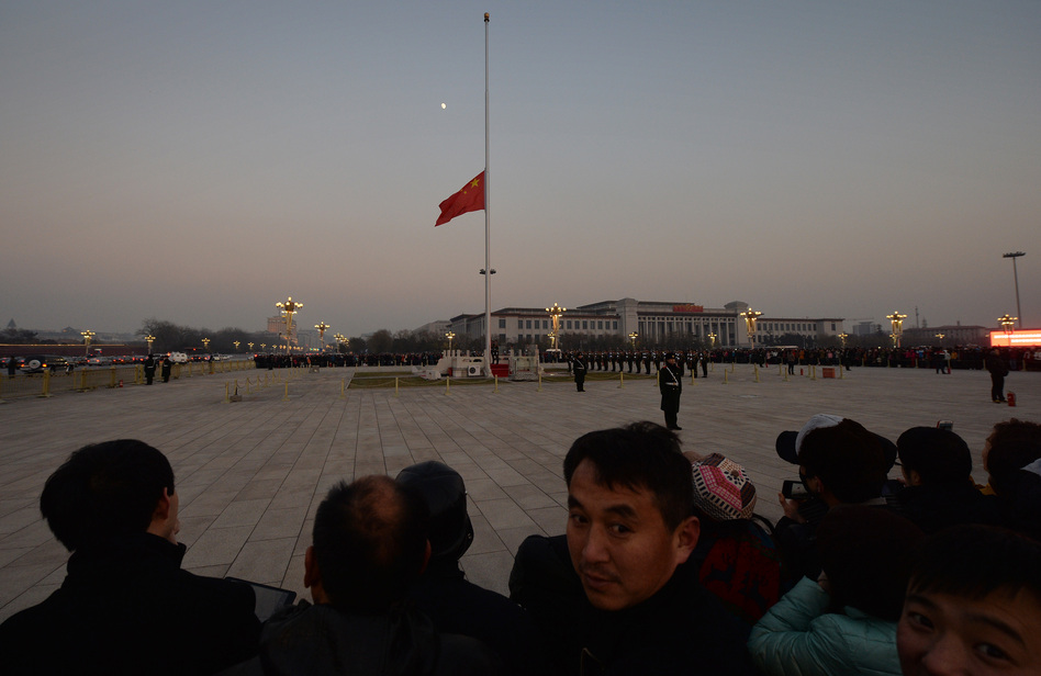 The Chinese flag is seen in front of a view of the moon at Beijing's Tiananmen Square in December, when China's first moon rover touched the lunar surface. That feat was widely celebrated — but observers believe the rover has now run into serious trouble.