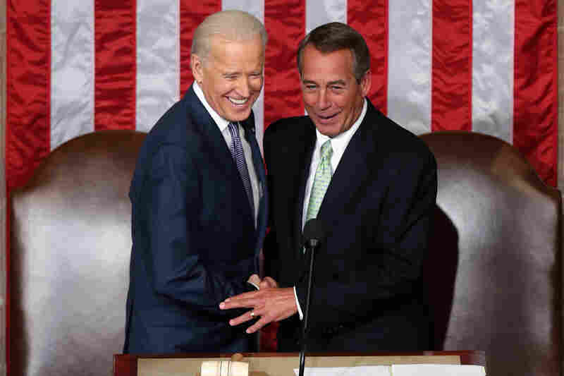 Biden and Boehner shake hands.