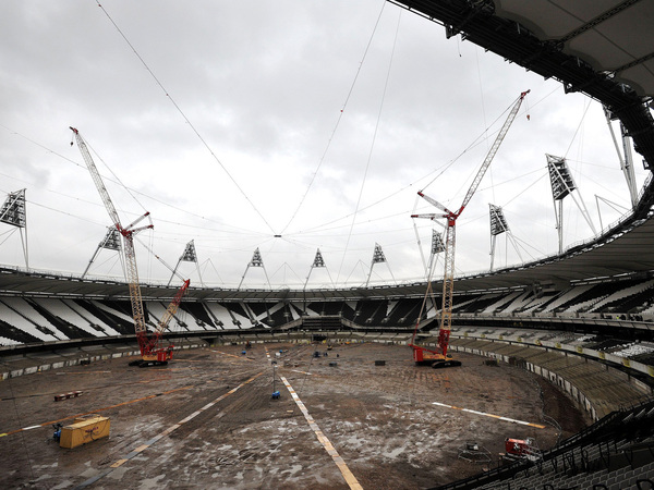 Cranes sit idle at the Queen Elizabeth Olympic Park Stadium in London on Nov. 11, 2013. Weather delayed work to transform it into a year-round multi-use venue, the home of West Ham United Football Club and the new national competition stadium for UK Athletics.