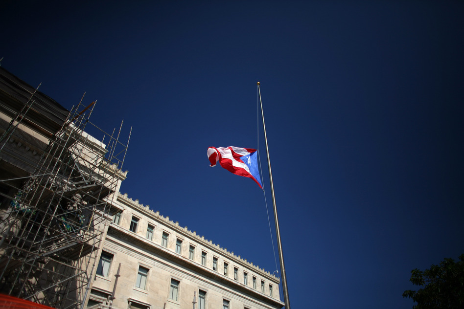 The Puerto Rican flag waves in front of the south wing of the Capitol in San Juan, Puerto Rico. (Ricardo Arduengo/AP)