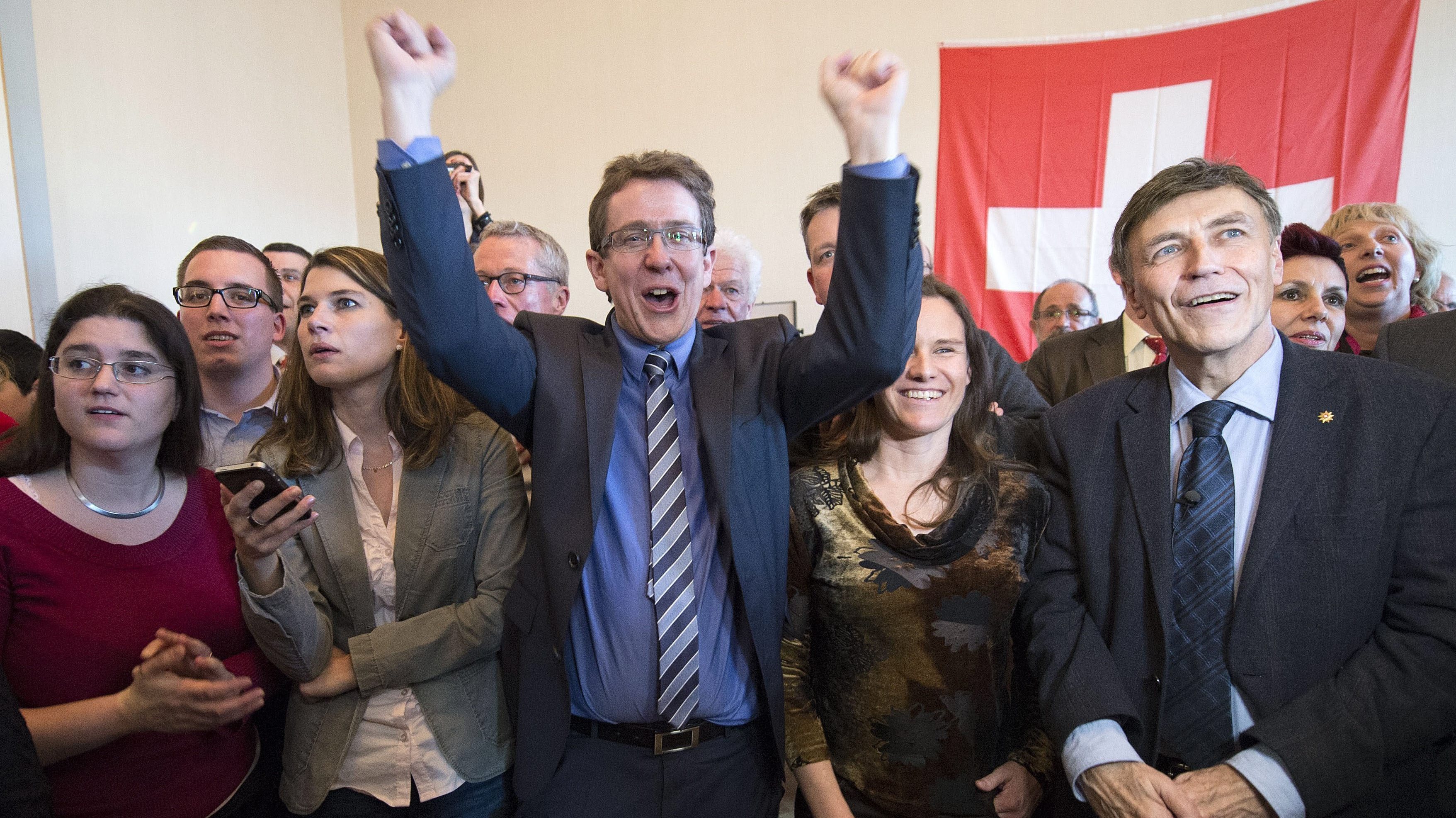 Members of the Swiss People's Party (SVP) cheer after the results after winning a narrow vote on an anti-immigration referendum on Sunday. (EPA/Landov)