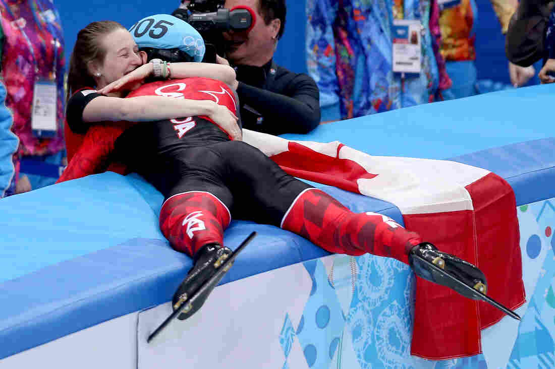 Gold medalist Charles Hamelin of Canada celebrates with his girlfriend and fellow speedskater, Marianne St-Gelais, after winning the men's 1500-meter short-track speedskating event Monday.
