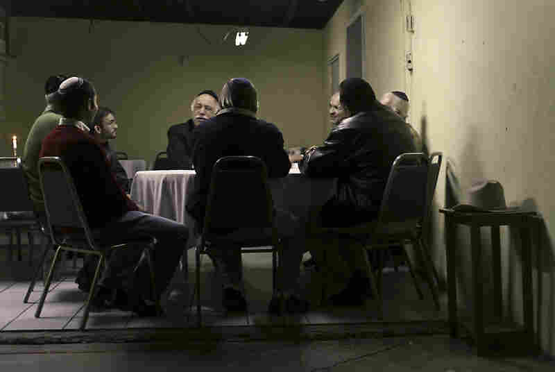 A group of men sits expectantly for Friday night dinner in Mexicali, Mexico.