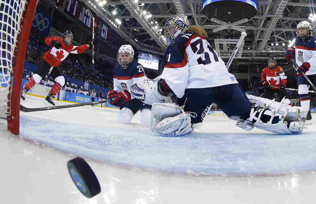 Goalkeeper Jessie Vetter and Kendall Coyne (26) of the United States look back at the puck as Meghan Agosta-Marciano of Canada celebrates her goal in Sochi on Wednesday. Canada defeated the United States, 3-2.