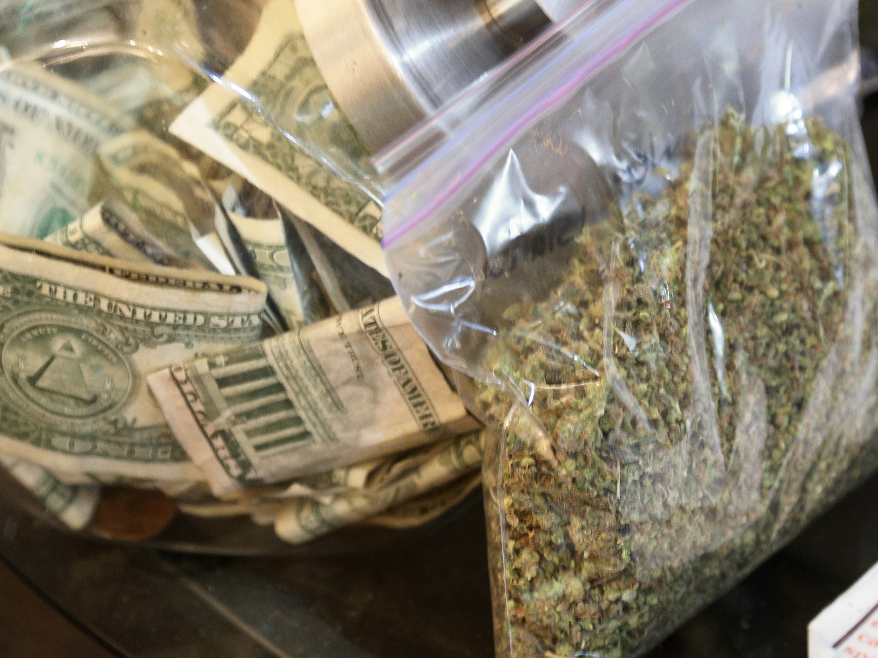 A bag of marijuana being prepared for sale sits next to a money jar at BotanaCare in Northglenn, Colorado, in this file photo taken on December 31, 2013. (Reuters/Landov)