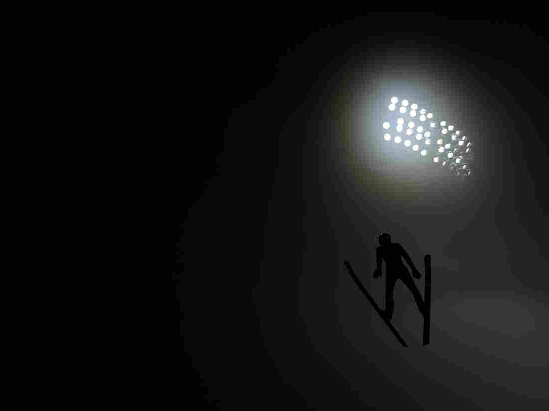 A competitor jumps through the fog during the Ski Jumping Men's Large Hill official training on day 9 of the 2014 Winter Olympics in Sochi.