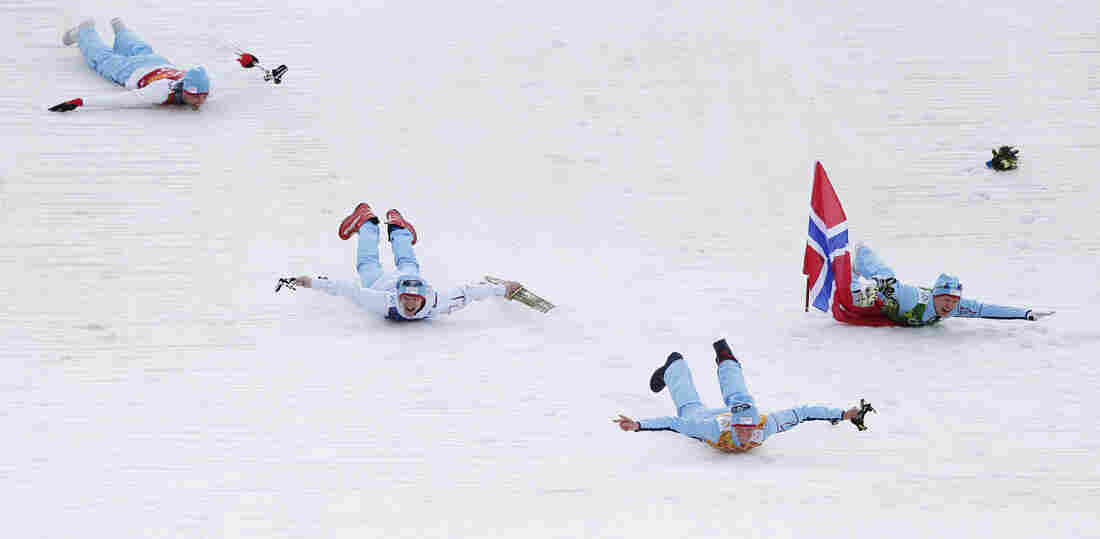 Norway's Magnus Hovdal Moan (from left), Joergen Graabak, Magnus Krog and Haavard Klemetsen dive as they celebrate winning the gold medal of the Nordic combined Gundersen large hill team competition at the 2014 Winter Olympics on Thursday in Krasnaya Polyana, Russia.