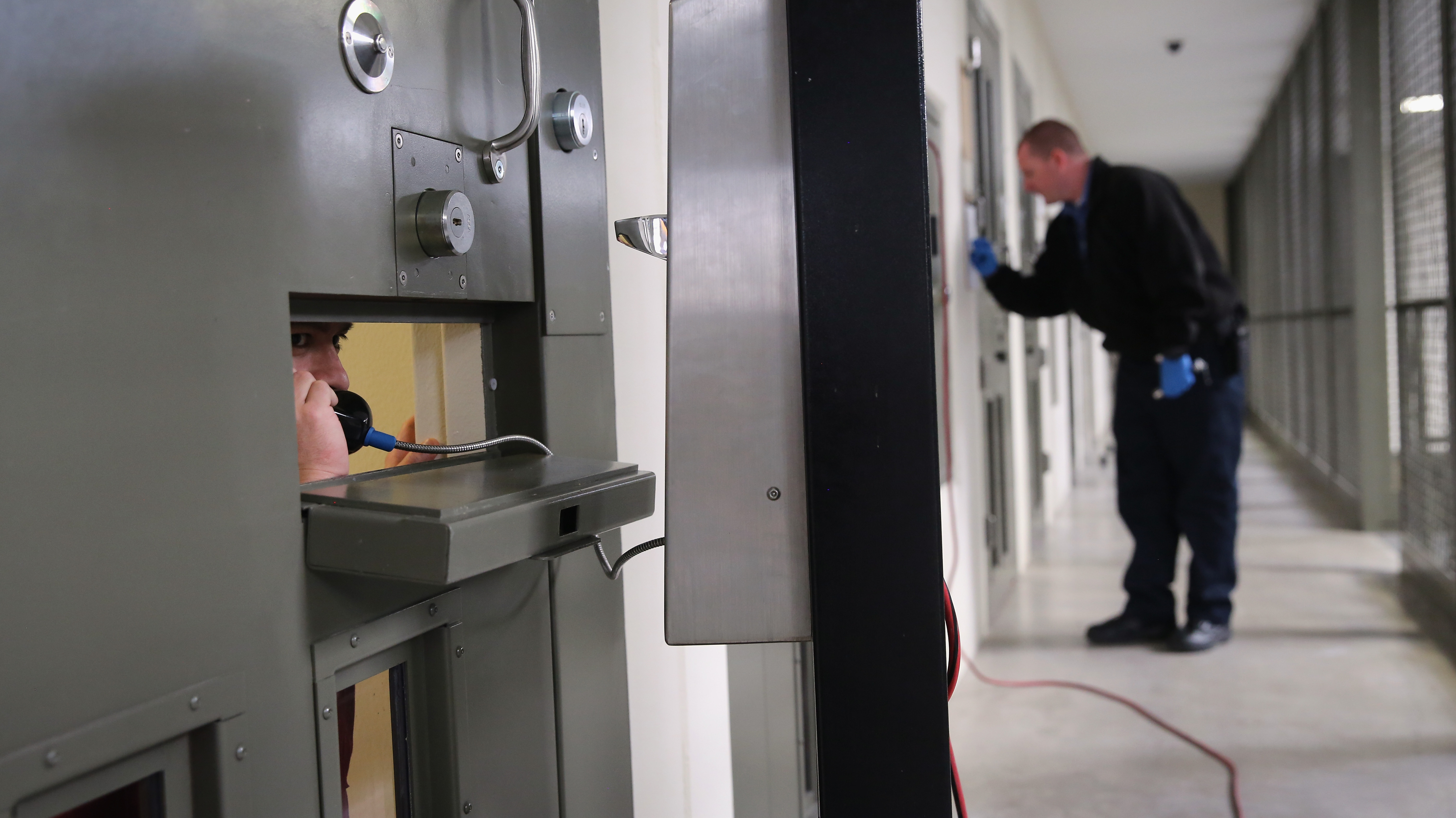 The U.S. holds more prisoners in solitary confinement than any other democratic country, according to critics of the treatment. Here, an immigrant detainee makes a call from his &quot;segregation cell&quot; at a detention facility in Adelanto, Calif., last November. (Getty Images)