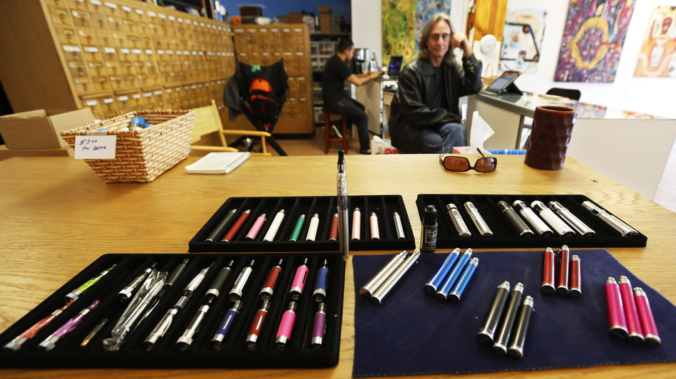 Electronic cigarettes for sale in Vapeology LA, a store in Los Angeles, are tended by owner John Hartigan. (Reed Saxon/AP)