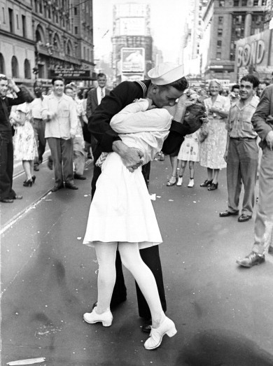 As pedestrians watch, an American sailor passionately kisses a white-uniformed nurse in Times Square to celebrate the long awaited-victory over Japan on August 14, 1945. (Time & Life Pictures/Getty Images)
