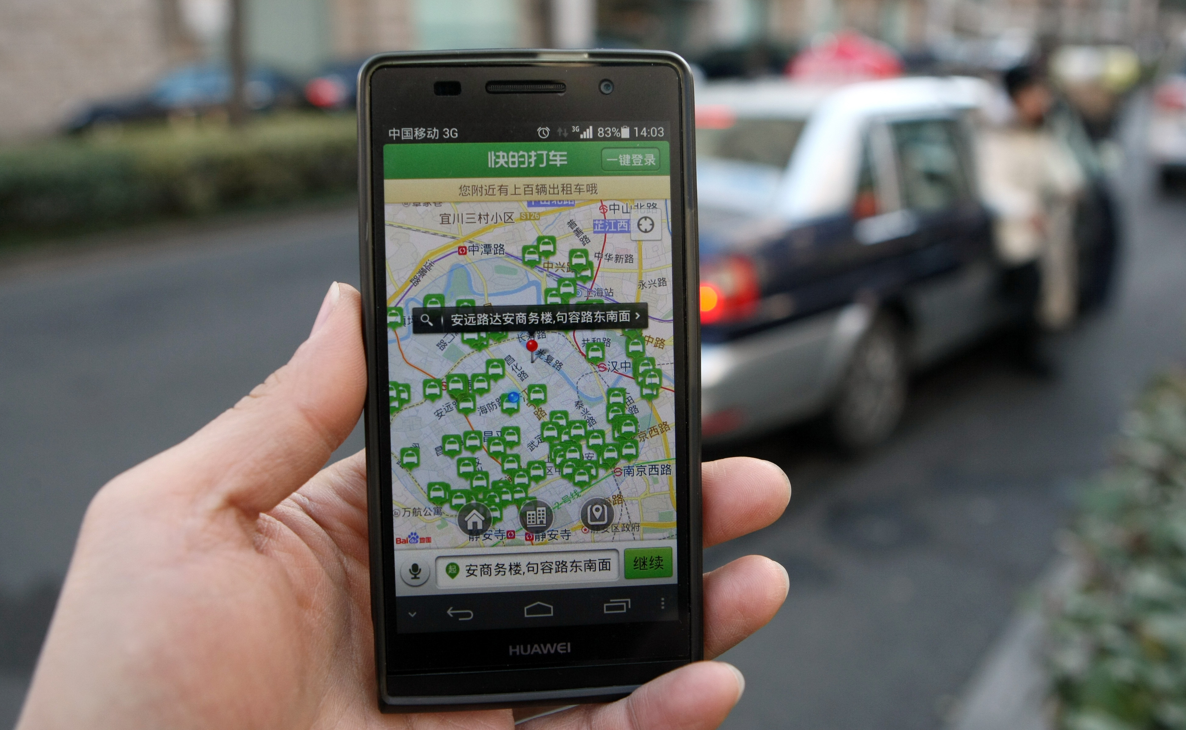 The Shanghai government has banned the use of taxi-booking apps such as Kuaidi Dache during rush hour. Here, a Shanghai resident displays the app on his smartphone in Shanghai, on Jan. 23. (Imagine China/Corbis)