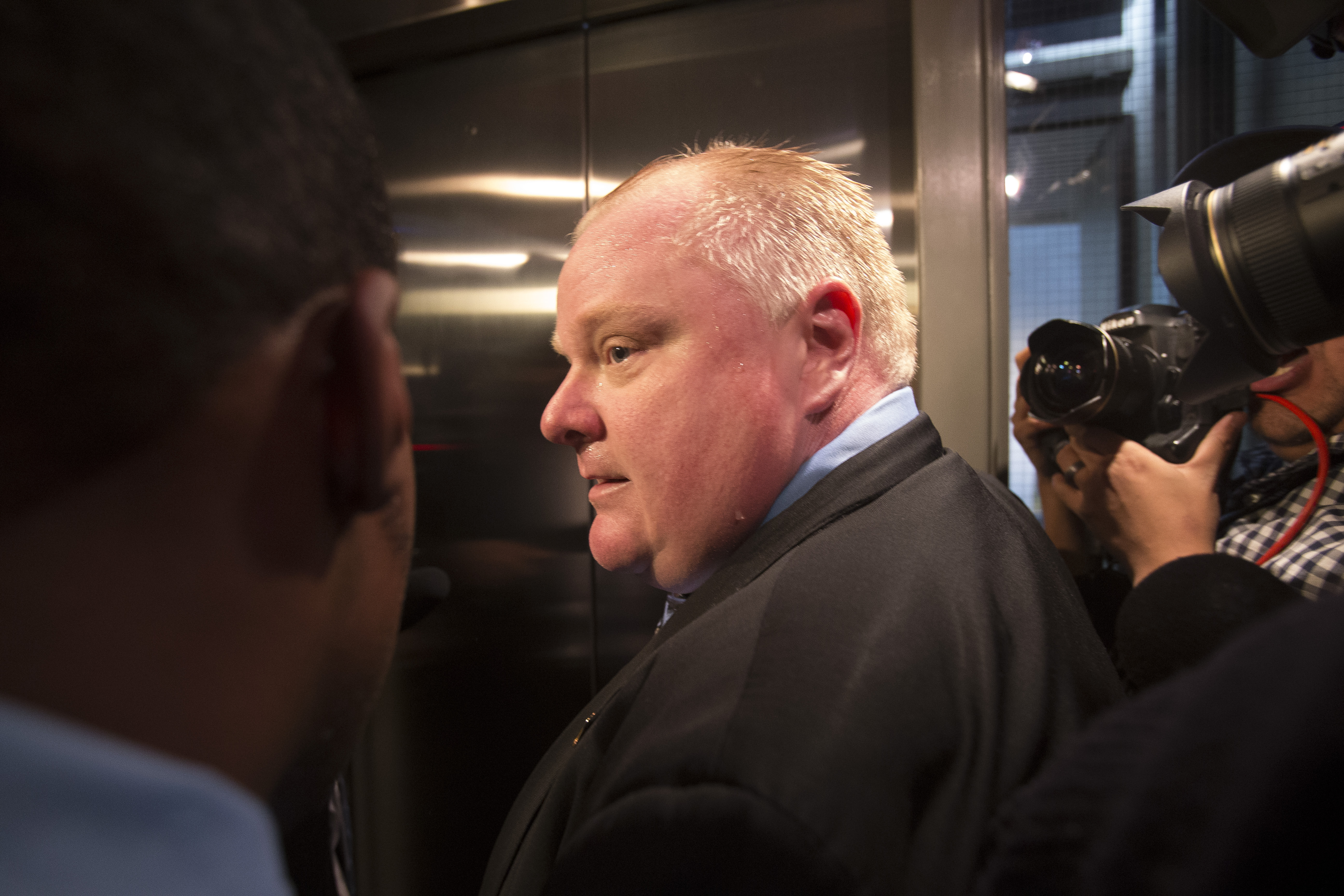 Toronto Mayor Rob Ford is surrounded by the media as he waits for an elevator outside his office at Toronto City Hall on November 15.