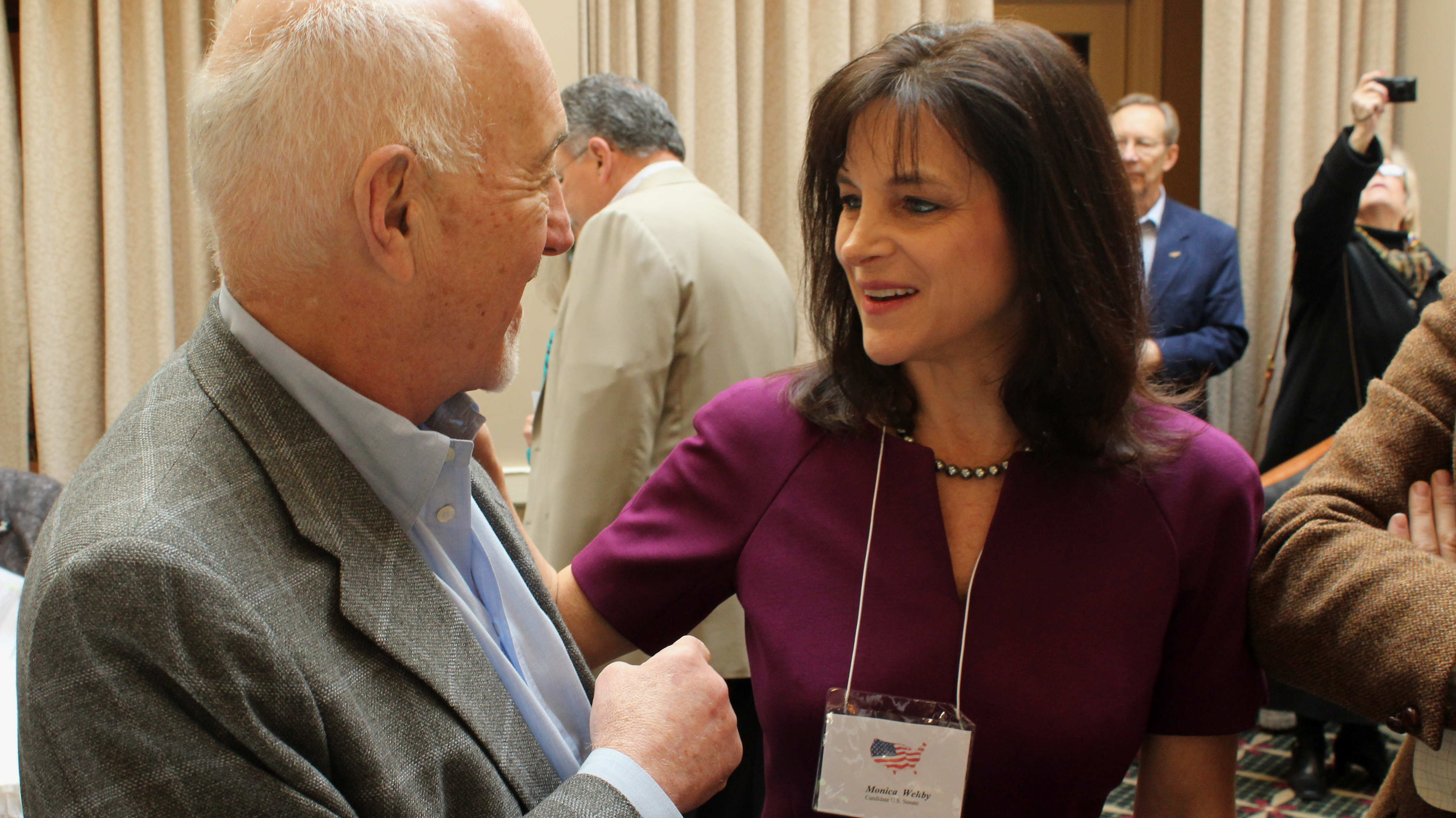 Oregon Republican Senate candidate Monica Wehby, right, talks to supporter Marvin Hausman in Lake Oswego, Ore. Wehby has drawn national attention and money in her effort to win her party's nomination.